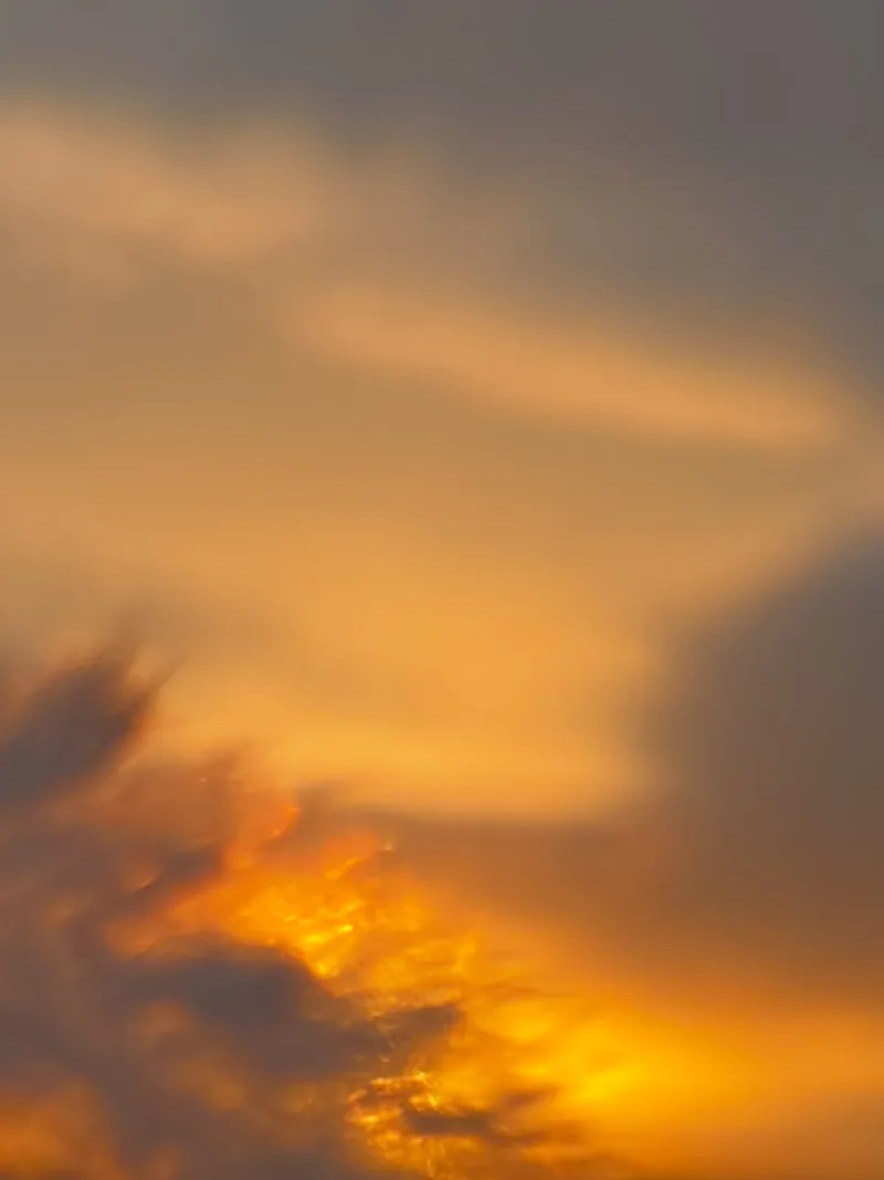 A soft, diffuse sunset, the light spreading through cloud
